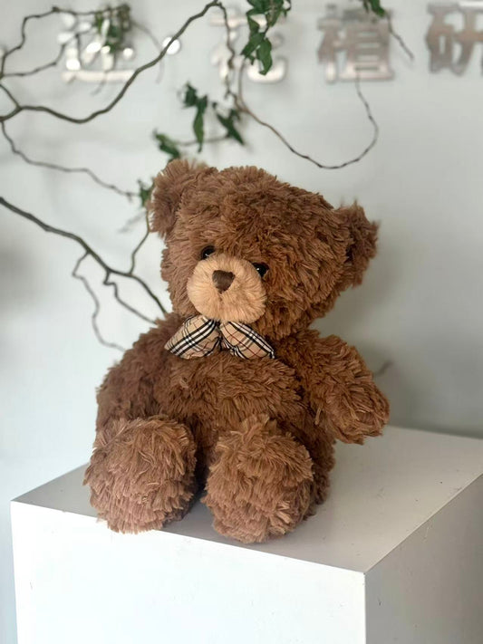 Teddy bear with plaid bow tie